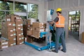 Genie SLA Straddle Base Lifting a Pallet